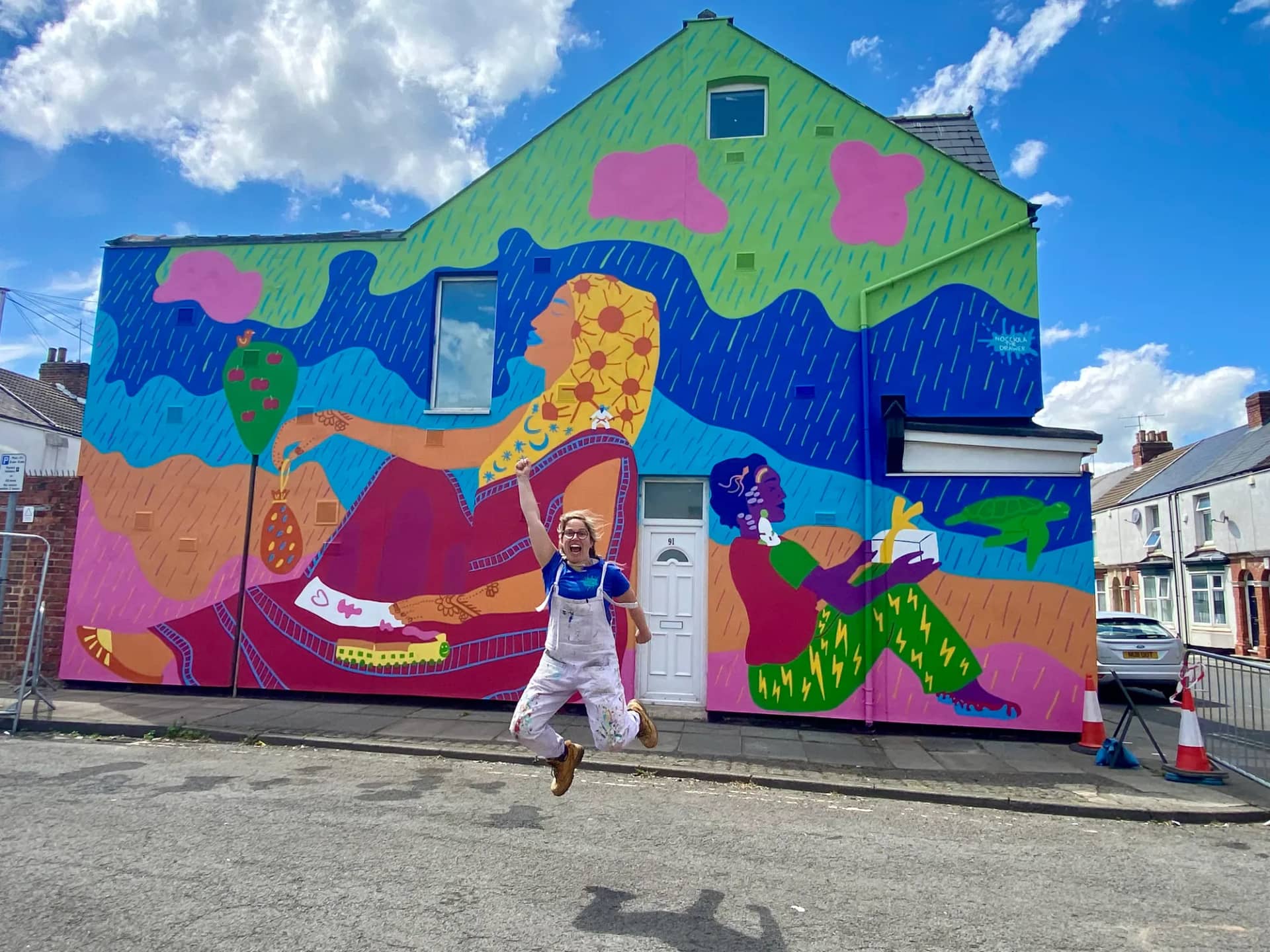 Hazel jumping in front of the Stories of Home mural in Gresham, Middlesbrough